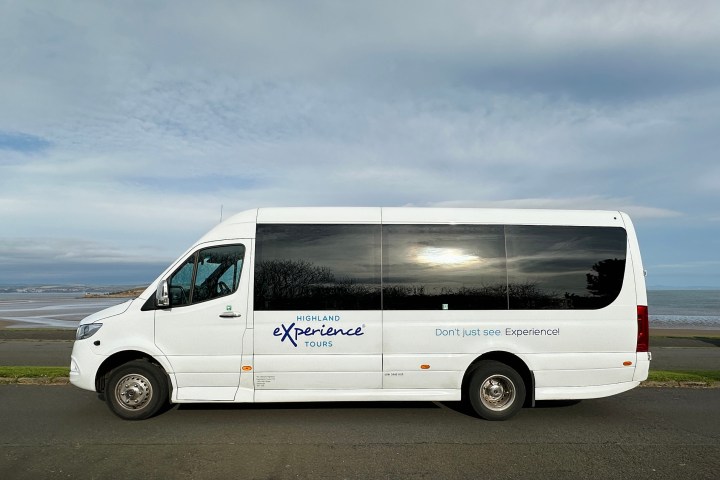 a van parked in front of a bus