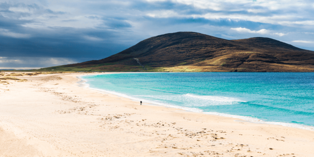 a beach with a mountain in the background