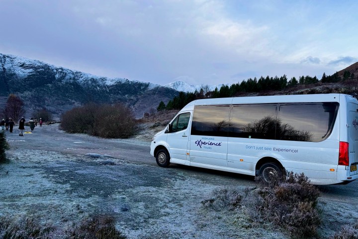 a van parked on the side of a snow covered mountain