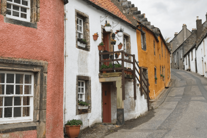 Colorful houses on a narrow cobblestone street.