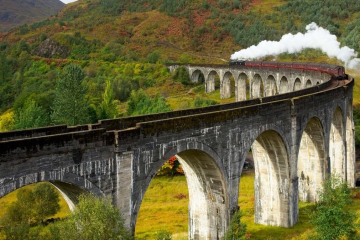 a train crossing a bridge over a river