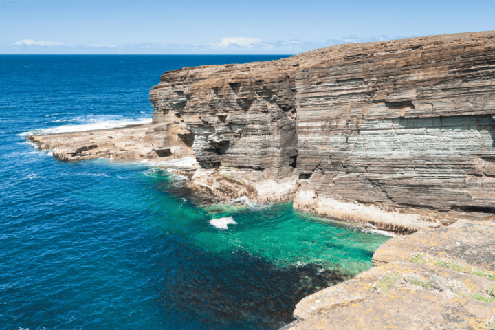 a rocky beach next to the ocean