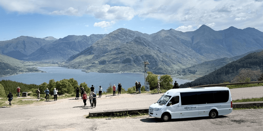 a bus is parked in front of a mountain