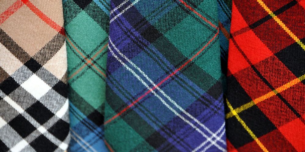 Four colorful plaid fabric patterns in beige, green, blue, and red.